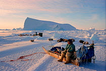 Inuit hunter resting on sled while hunting in Melville Bay, Northwest Greenland, 1998.