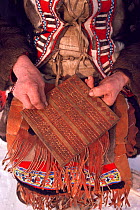 Traditional Even calendar - a wooden board with pegs to mark days and months. Chukotka, Siberia, Russia, 1994.