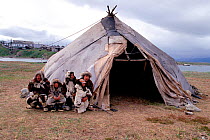 Chukchi family standing by their Uranga (canvas tent). Yanrakynnot, Chukotka, Siberia, Russia.