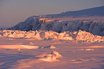 Low winter sun shining on pressure ice near Cape Dezhnev. Chukotka, Siberia, Russia.