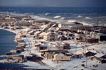 Town of Uelen exposed to heavy seas during autumn storm. Chukotka, Siberia, Russia, 2004.