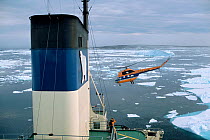 MI-2 helicopter preparing to land on rear deck of Russian Icebreaker "Kapitan Dranitsyn". Franz Josef Land, Russia, 2004.