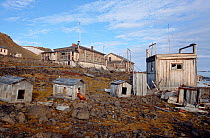 Old buildings and dog kennels at old polar station at Tichaya Bay. Hooker Island, Franz Josef Land, Russia, 2004.