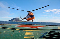 MI-2 helicopter landing on rear deck of Russian Icebreaker "Kapitan Dranitsyn". Franz Josef Land, Russia, 2004.