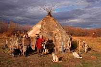 Two Chukchi women and Huskies (Canis familiaris)outside Reindeer skin yurt near Khailino. Koryakia, Kamchatka, Siberia, Russia, 1999.