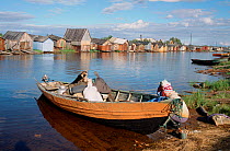 Sami family preparing to leave Lovozero on summer fishing trip by boat. Kola Peninsula, Northwest Russia, 2005.