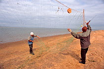 Nivkhi fishermen cleaning their salmon nets in Niva Bay near Nogliki. Sakhalin Island, Russia, 2006.