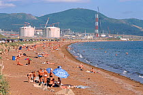 Bathers on beach at Pregorodnaye where Sakhalin Energy's Liquid Natural Gas processing facility is under construction. Sakhalin Island, Russian Far East, 2006.