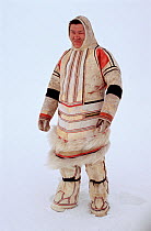 Nganasan man wearing traditional dress made from reindeer / caribou skin. Taymyr, Northern Siberia, Russia, 2004.