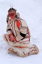 Nganasan man wearing traditional clothing made from reindeer / caribou skin and Shaman's headdress. Taymyr, Northern Siberia, Russia, 2004.