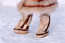 Nganasan woman wearing traditional cylindrical Reindeer / Caribou skin boots. Taymyr, Northern Siberia, Russia, 2004.