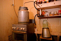 Homemade still for making Samagon (homebrewed vodka) on a kitchen stove. Moscow, Russia, 2003.