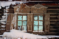 Frosted windows and carved wooden details on an old building in Yakutsk. Yakutia, Siberia, Russia, 1999.