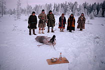 Forest Nenets using vodka as an offering during ritual sacrifice of Reindeer / Caribou (Rangifer tarandus). Numto, Khanty Mansiysk, Western Siberia, Russia, 2000.