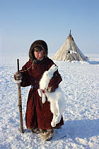 Tundra Nenets boy posing with Arctic hare (Lepus arcticus) he has shot. Gydan Peninsula, Western Siberia, Russia, 2000.