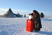 Tundra Nenets woman voting in Russian presidential elections at her camp. Gydan Peninsula, Western Siberia, Russia, 2000.