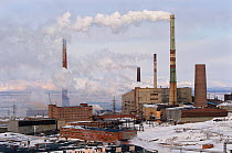 Smoke containing sulphur dioxide belching from the chimney of a nickel foundry at Norilsk, Western Siberia, Russia, 2000.