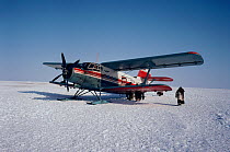 An Antonov II biplane on skis landing on tundra during the winter. Yamal, Siberia, Russia, 1993.