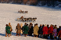 Nenets men watching Reindeer / Caribou (Rangifer tarandus) racing during local festival. Yamal, Siberia, Russia, 1996.