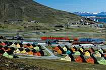 Brightly coloured wooden homes by the shopping centre, with view to Gamle Longyearbyen. Svalbard, Norway, 2004.