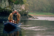 Fishing from a small boat on a misty morning. Campsie Lin, River Tay, Scotland.
