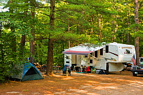 A Recreational vehicle / camper van parked in the forests, White Lake State Park in Tamworth, New Hampshire, USA. October 2009