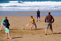 Family playing beach cricket, Cornwall, UK. Model released, April 2009