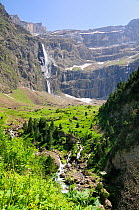 Waterfalls, karst limestone cliffs, montane pastureland and upper River Gave at the Cirque de Gavarnie, Pyrenees National Park, Haute Pyrenees, France. July 2009