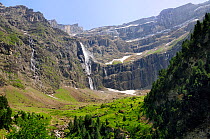 Waterfalls, karst limestone cliffs and montane pastureland at the Cirque de Gavarnie, Pyrenees National Park, Haute Pyrenees, France. July 2009