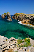 Castro de Gaviotas (Gull's fort) karst limestone rock archway and sea channel leading to narrow La Canalina beach, near Llanes, Asturias, Spain. July 2009
