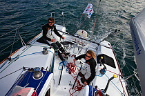 Jeanne Gregoire and Gerald Veniard aboard Figaro yacht "Banque Populaire". Transat AG2R, Port la Foret, Brittany, France. April 2010. Editorial use only.