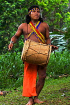 A young Embra Indian man creating traditional music, Soberania NP, rainforest, Panama, November 2008
