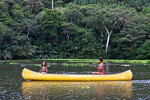 Father and daughter Wounaan indians canoeing down the Chagres river, Panama, November 2008, Model released