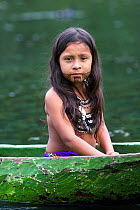 Portrait of a young kuna Indian girl in a traditional hand carved wooden canoe, Panama, November 2008, Model released