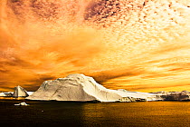 Sunset over iceberg. Jakobshavn, Ilulissat, Kangia, Icefjord, Greenland. August 2006.
