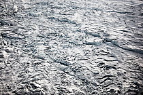 Aerial view of mountains and melting sea ice. Jakobshavn, Ilulissat, Kangia, Icefjord, Greenland. October 2008.
