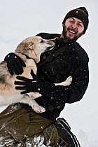 Portrait of photographer Uri Golman with Greenland husky sled dog, North East Greenland. March 2009. Model released
