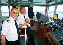 Captains on deck of Scillonian III off Land's End, Cornwall. Model Released.