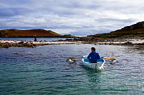 Man in rowing boat off Arthur, Eastern Isles, Isles of Scilly, UK, Model Released.