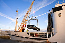 Car being loaded onto passenger ferry "Scillonian III" at Penzance Quay, before travelling to the Isles of Scilly, UK.