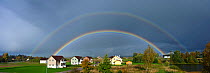 Double rainbow across village landscape, Estonia, Summer
