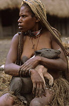 Portrait of Dani woman holding a piglet in her arms, Wamena, Baliem valley, West Papua, former Irian-Jaya, Indonesia, August 2002 (West Papua).