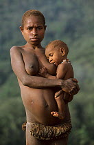 Portrait of young Yali woman breast-feeding her baby. West Papua, former Irian-Jaya, Indonesia, August 2002 (West Papua).