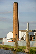 Former industrial feature (chimney) in newly developed Gloucester docks. Severn Estuary. Industrial activity beside Industrial Revolution waterways.  Gloucestershire, England, UK. September 2009