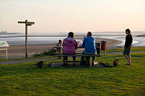 People relaxing and walking on Severn side walk. Gloucestershire, England, UK. September 2009