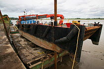 Barge in dry dock at Bulls Pit. Fred Larkham, Gloucestershire boatman. Severn Estuary. England, August 2009