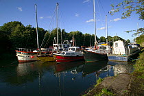 Boats in Lydney harbour, medieval harbour linking Lydney with South East to supply timber, grain, coal, tinplate to Severn Estuary. England, August 2009