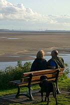 Tourists / local residents enjoying views of the Severn Estuary. Severn bridge in background. England, August 2009