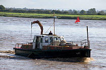 Fred Larkham (Gloucestershire boatman) and wife on board their working boat in the Severn Estuary. England, August 2009