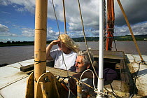 Fred Larkham (Gloucestershire boatman) and wife on board their working boat in the Severn Estuary. England, August 2009